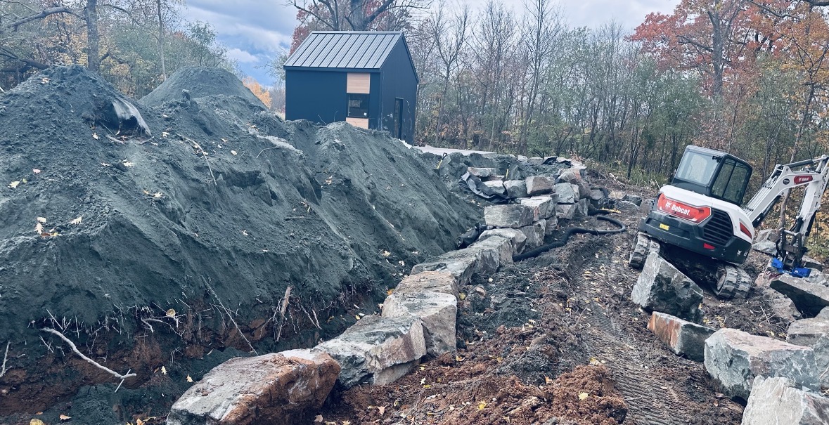 Setting boulders for a wall