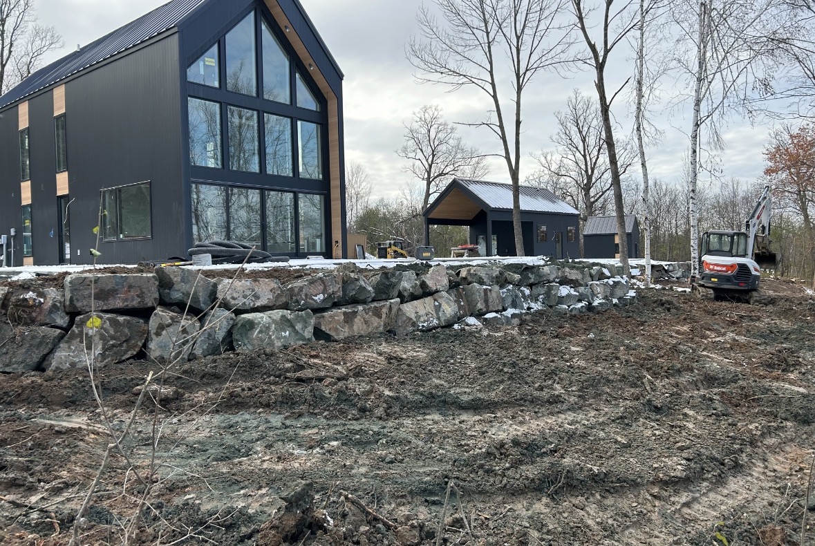 Boulder wall at modern home