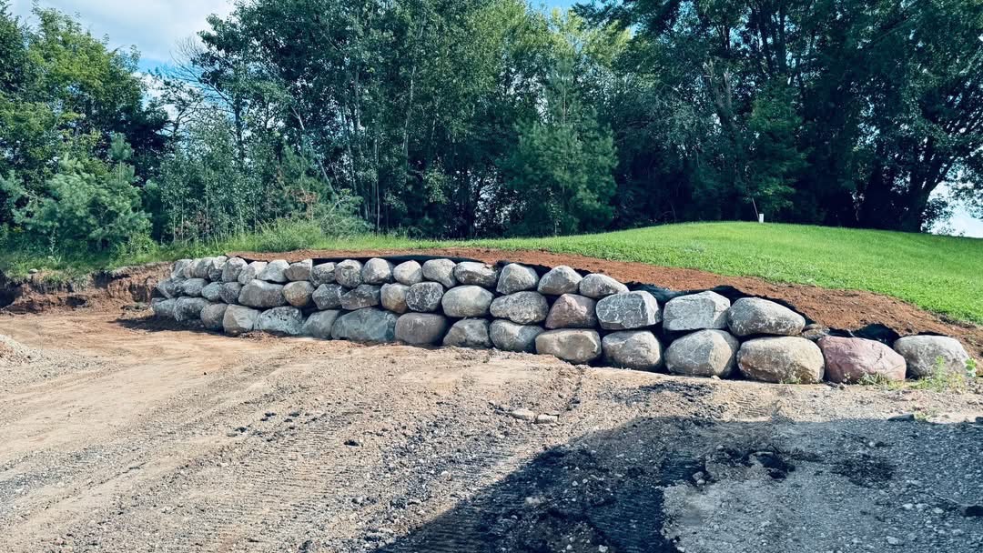 Boulder wall along driveway